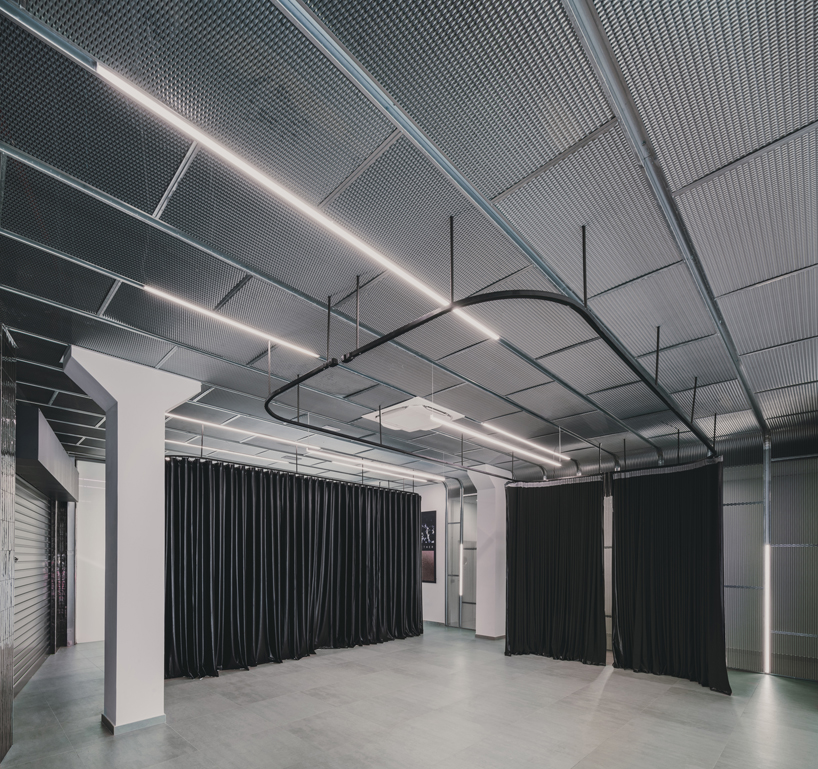 OOIIO wraps reused madrid auto center in permeable skin of vertical metal slats - 11