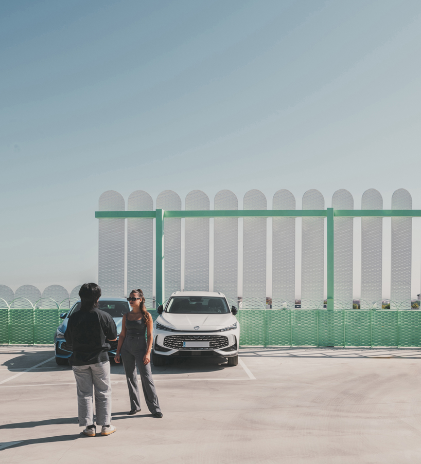 OOIIO wraps reused madrid auto center in permeable skin of vertical metal slats - 6