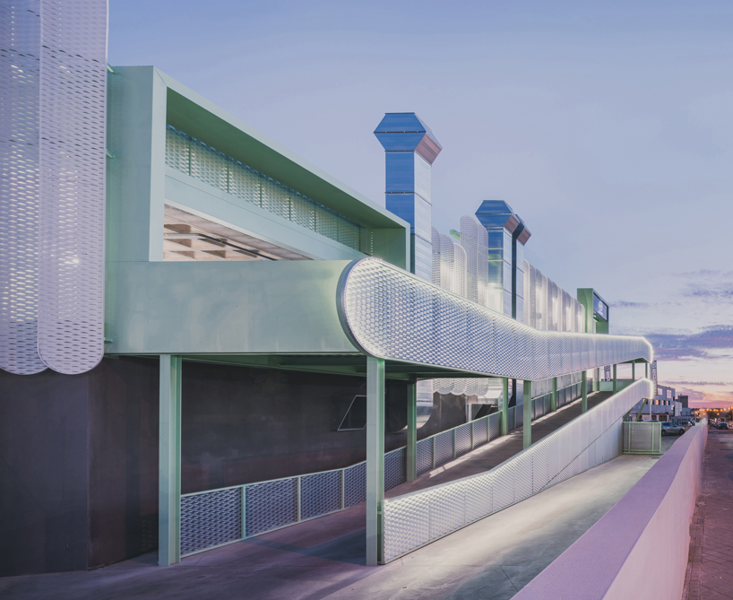 OOIIO wraps reused madrid auto center in permeable skin of vertical metal slats - 12