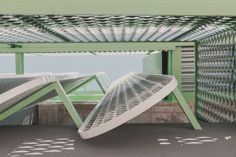 OOIIO wraps reused madrid auto center in permeable skin of vertical metal slats - 7