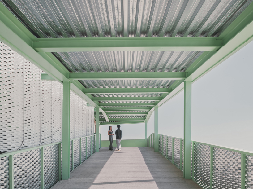 OOIIO wraps reused madrid auto center in permeable skin of vertical metal slats - 8