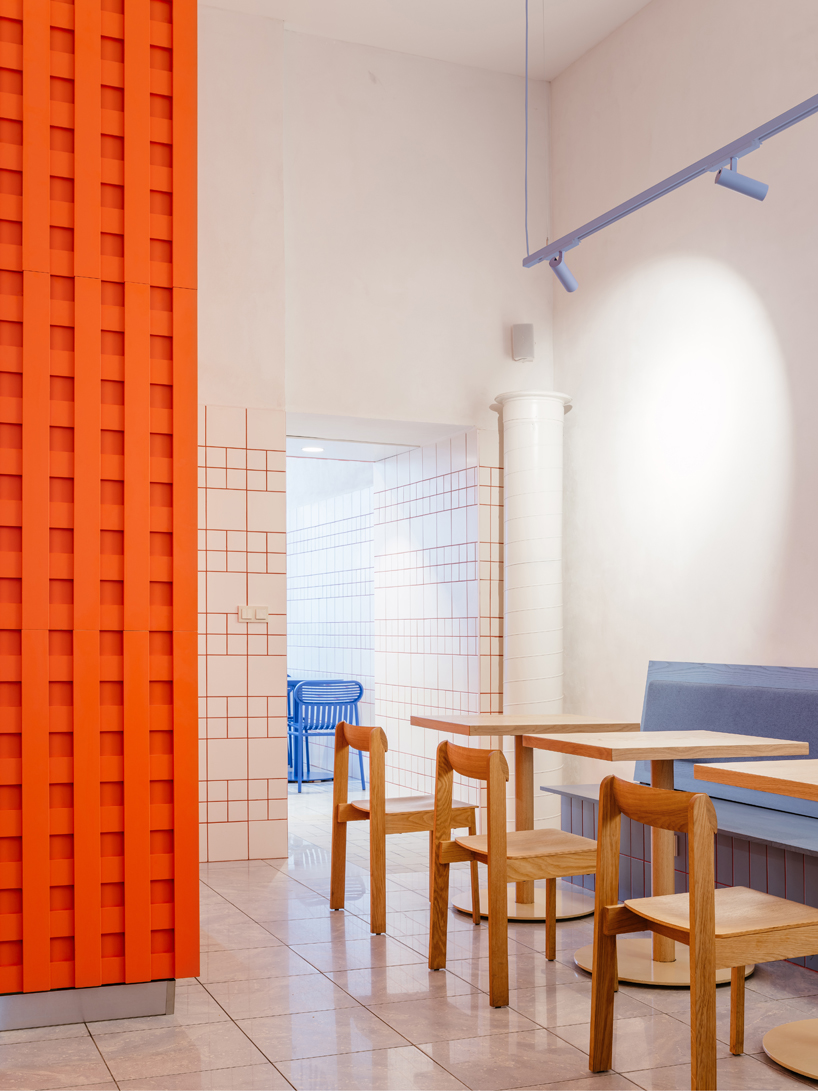 blue, red, and orange interiors bring seoul’s visual energy to the kimchi restaurant in prague - 9
