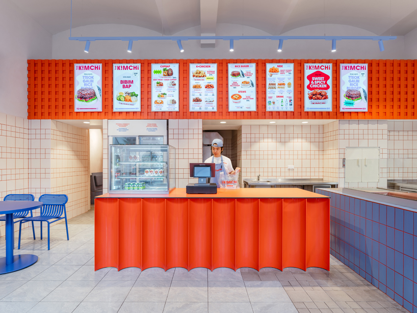 blue, red, and orange interiors bring seoul’s visual energy to the kimchi restaurant in prague - 5