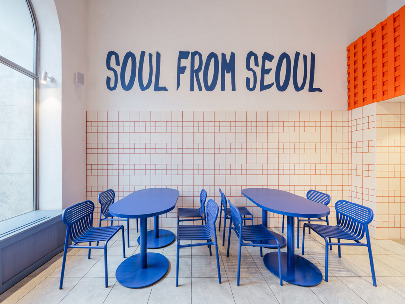 blue, red, and orange interiors bring seoul’s visual energy to the kimchi restaurant in prague - 6