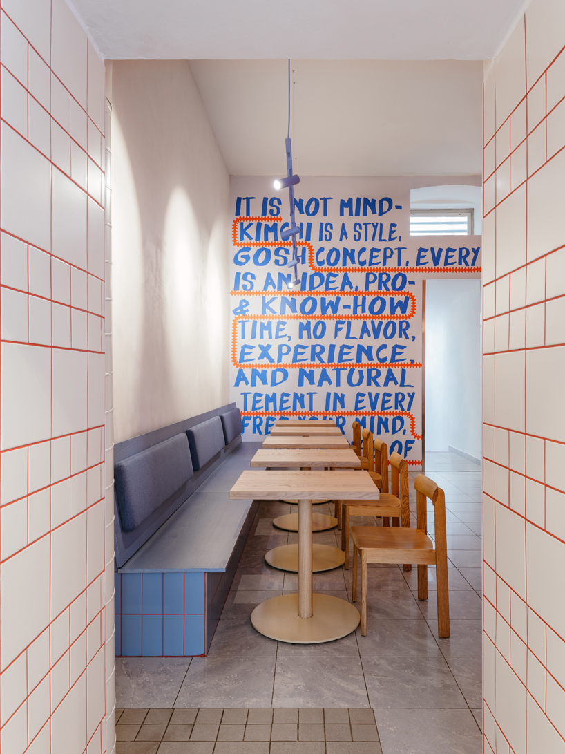 blue, red, and orange interiors bring seoul’s visual energy to the kimchi restaurant in prague - 8