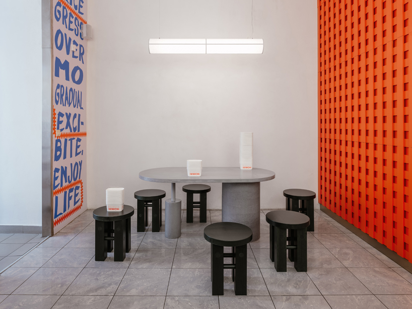 blue, red, and orange interiors bring seoul’s visual energy to the kimchi restaurant in prague - 7
