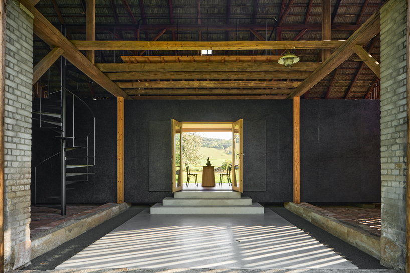 black asphalt and birch plywood shape compact retreat within czech barn - 5