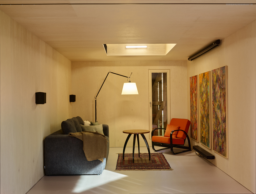 black asphalt and birch plywood shape compact retreat within czech barn - 9