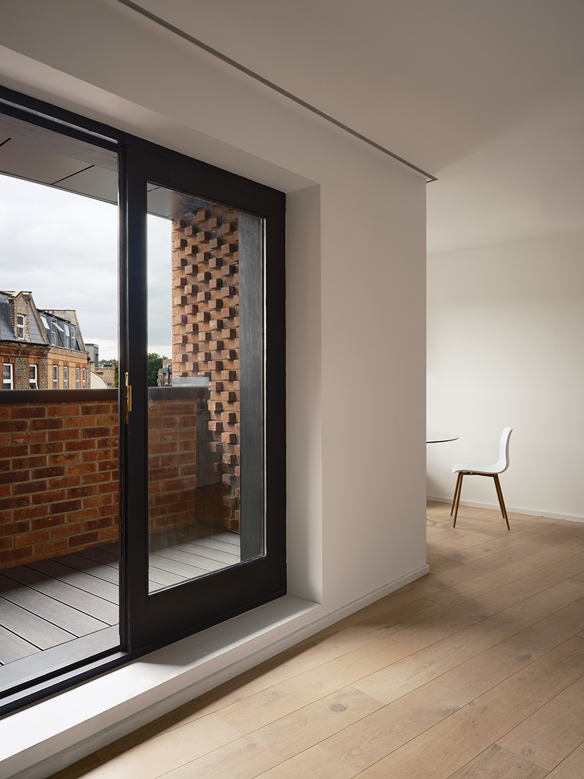 DROO covers residential unit's protruding volumes in textured brickwork in london