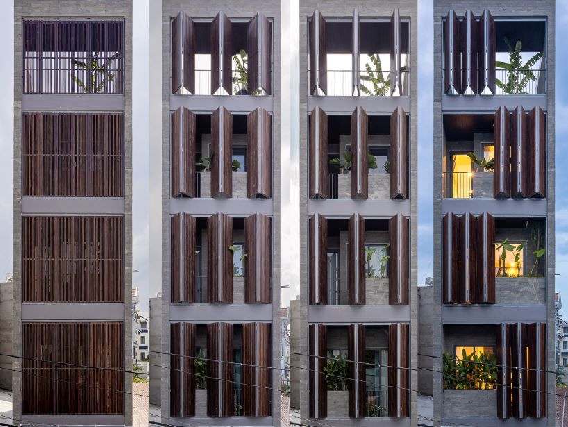 folding teak shutters weave light and nature into pham trung's narrow home in vietnam