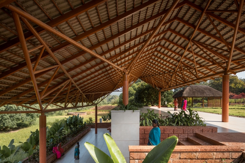 gabled roof floats over gathering pavilion’s brick stepped plinths in india - 6