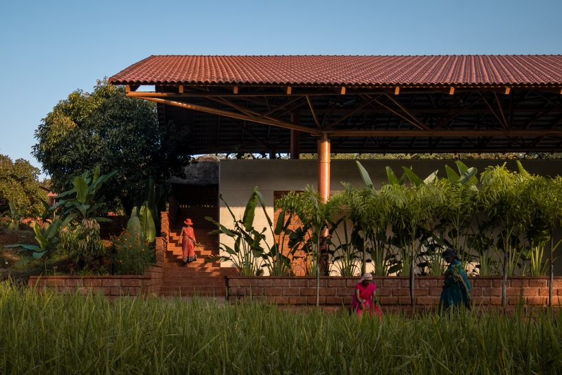 gabled roof floats over gathering pavilion’s brick stepped plinths in india - 5