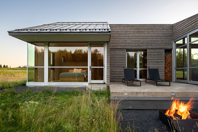 stillwater residence emerges as a series of farm sheds within verdant veil of montana