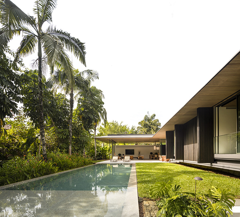 L-shaped weekend house by jacobsen arquitetura enjoys close connection to nature in são paulo