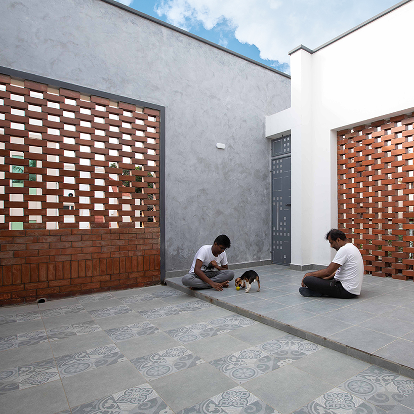 perforated brick planes invite light and shade into D.L.E.A's house in chennai