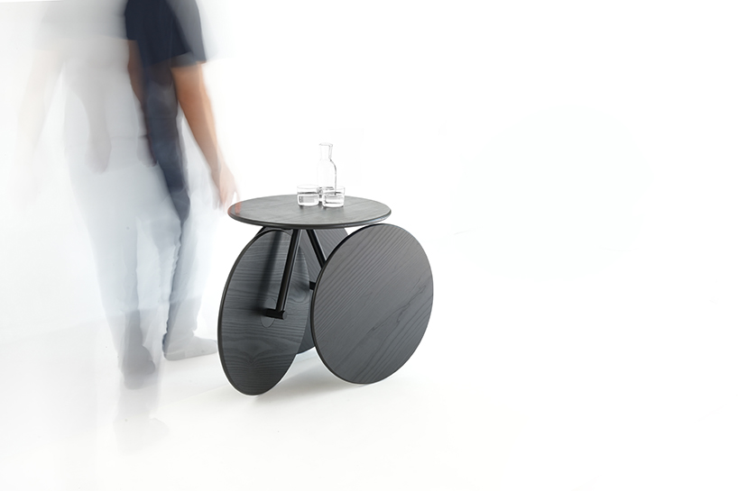 four identical wooden circles sculpt rolling table by mike & maaike