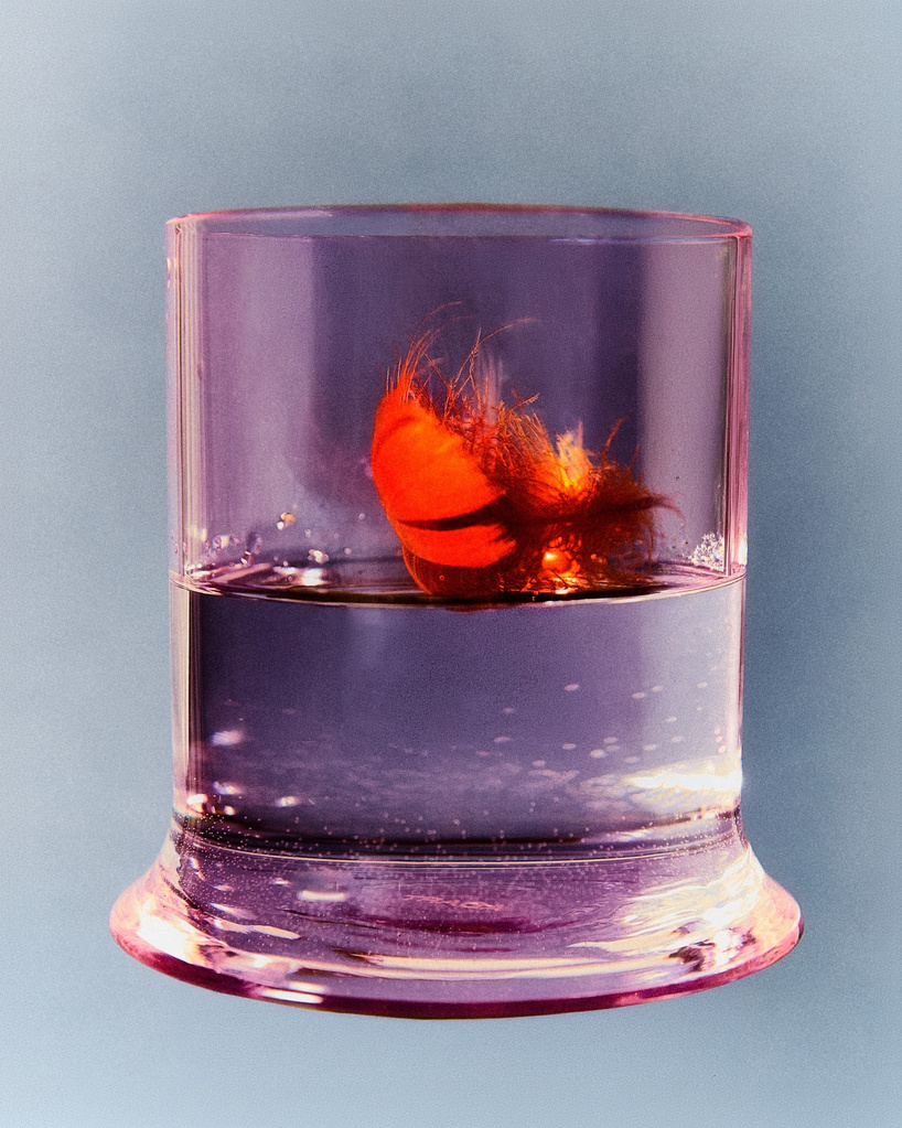 borosilicate drinking glass creates optical illusion of liquid melting into table - 5