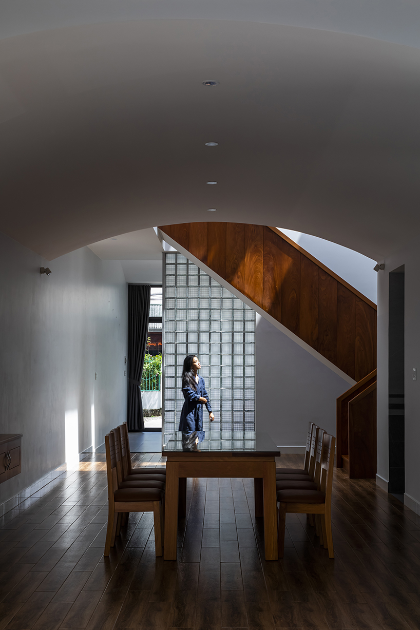 two ample voids afford openness and interaction for family house in vietnam