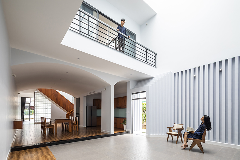 two ample voids afford openness and interaction for family house in vietnam