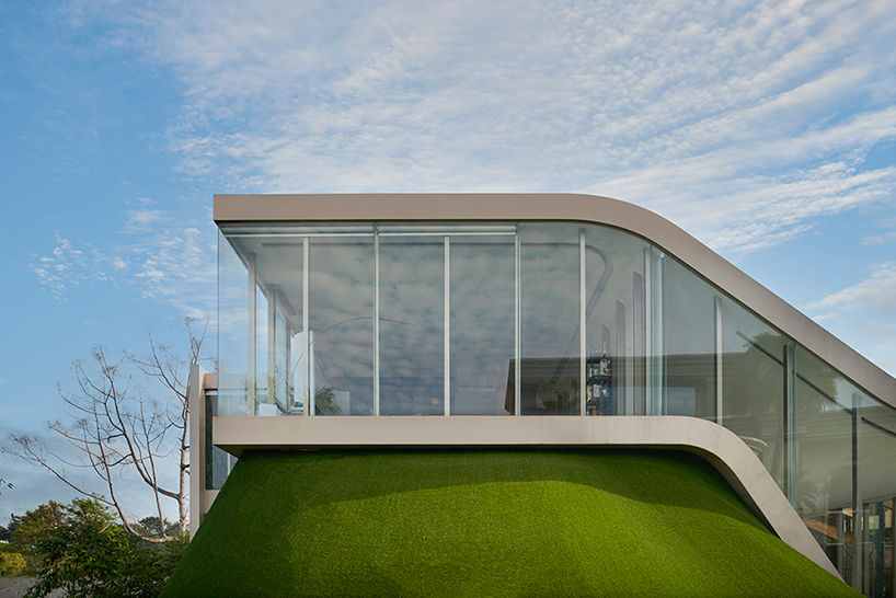 ripple-shaped family house in indonesia adapts to feng shui for optimal living