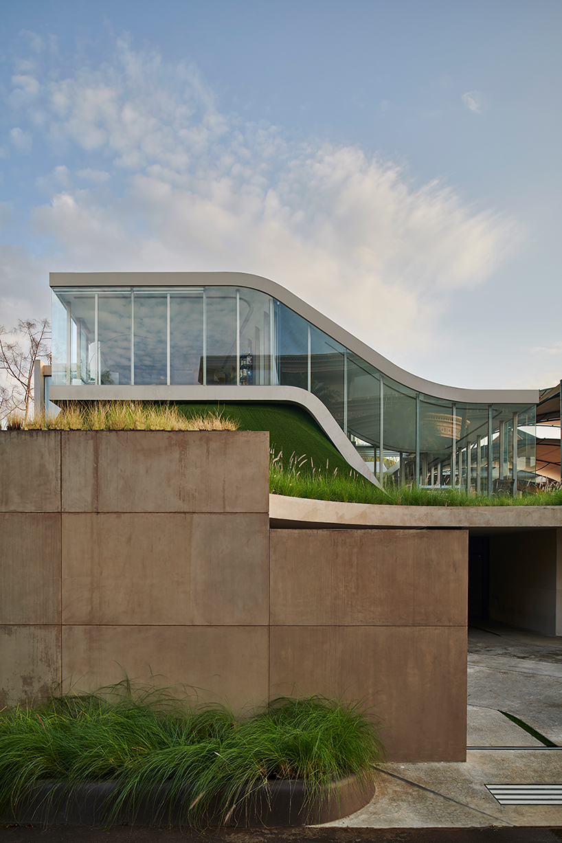 ripple-shaped family house in indonesia adapts to feng shui for optimal living