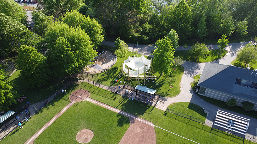 vanishing community room by alsar atelier uses tree stakes and textile canopies for shading
