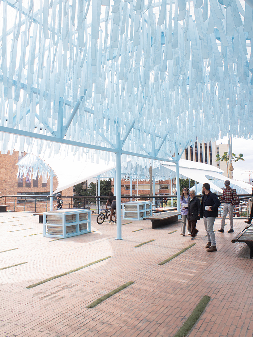 blue fabric fragments dance with the wind on modular cultural pavilion in colombia
