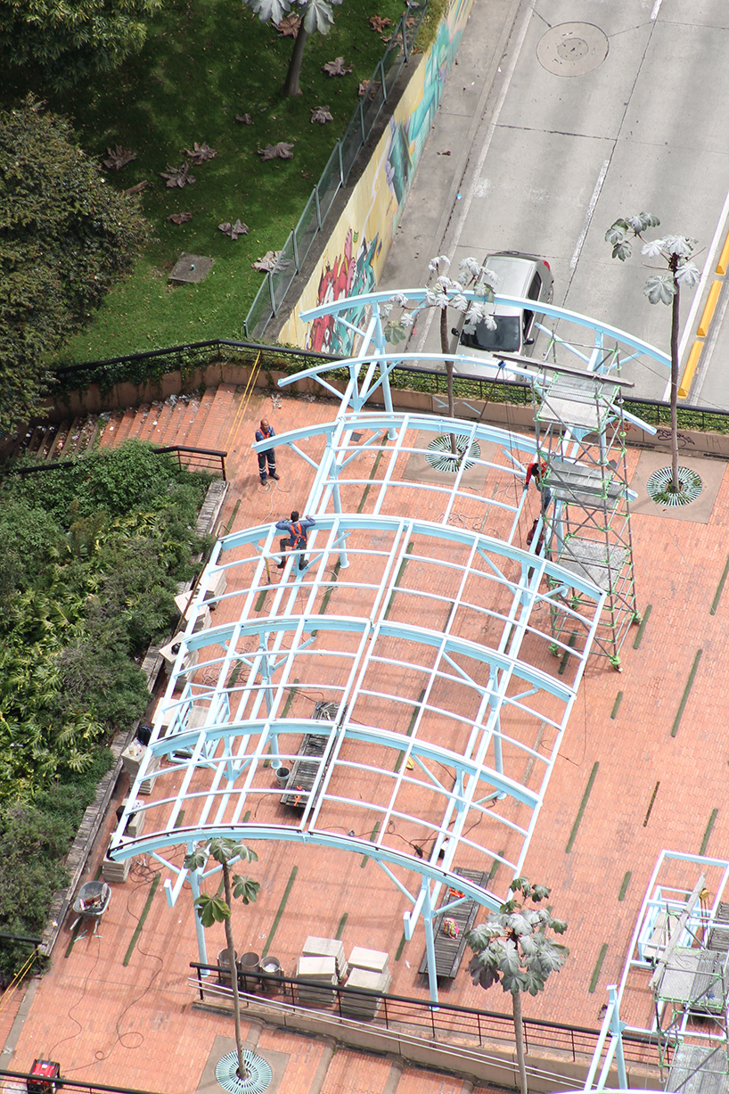 blue fabric fragments dance with the wind on modular cultural pavilion in colombia