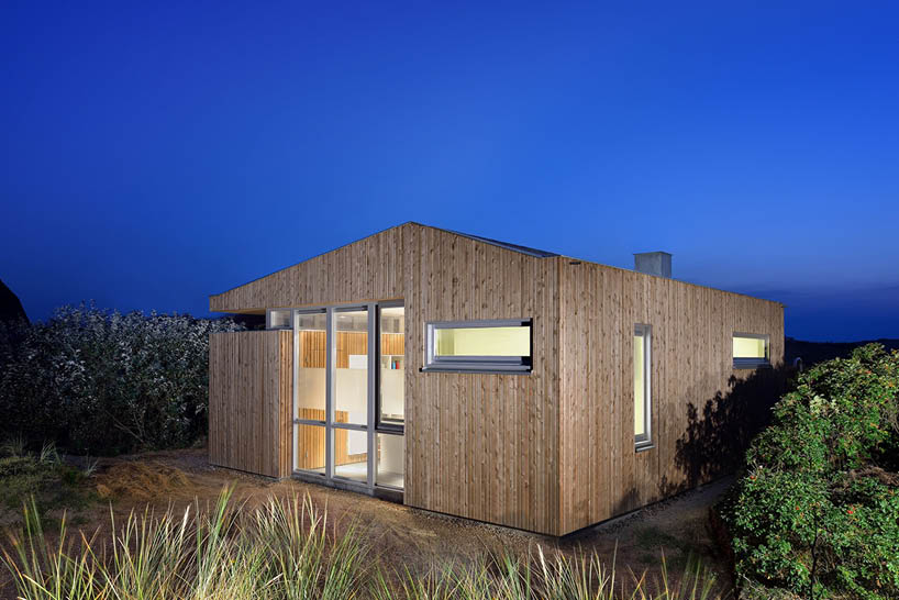 'tiny house vlieland' unfolds to blend with dutch island's dune landscape