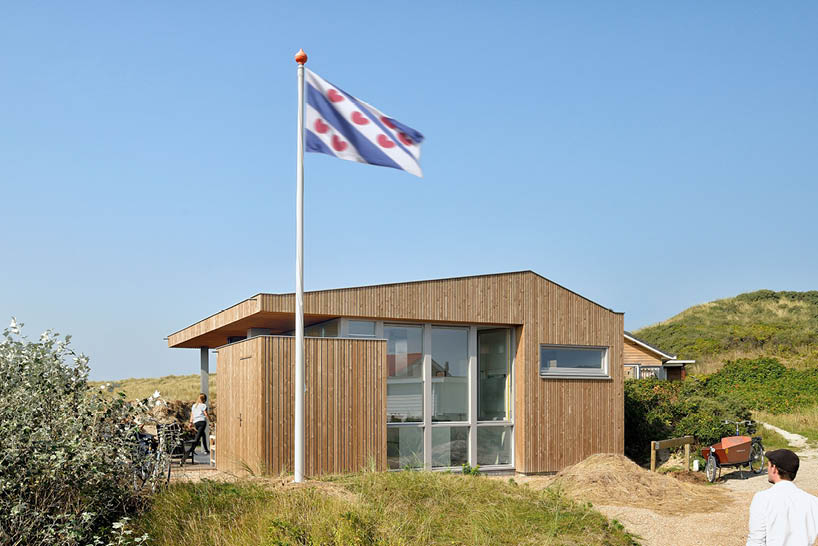 'tiny house vlieland' unfolds to blend with dutch island's dune landscape