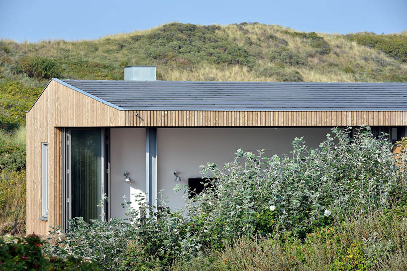 'tiny house vlieland' unfolds to blend with dutch island's dune landscape
