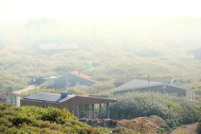 'tiny house vlieland' unfolds to blend with dutch island's dune landscape