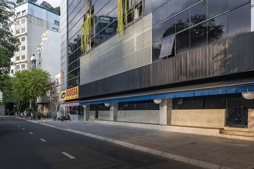 indigo fabric partitions float above sculpted concrete counters in rokusho bar by inrestudio