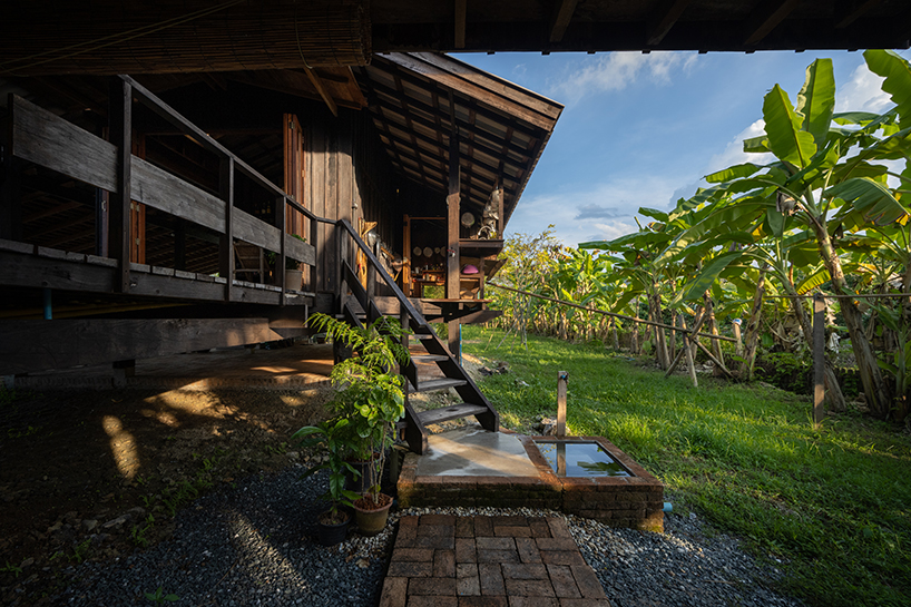 local wood joinery technique assembles roofed residence in northern thailand