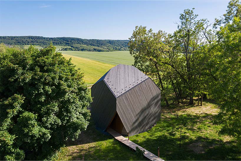 hello wood's resort weaves six boulder-like cabins into rural hungary