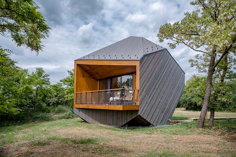 hello wood's resort weaves six boulder-like cabins into rural hungary