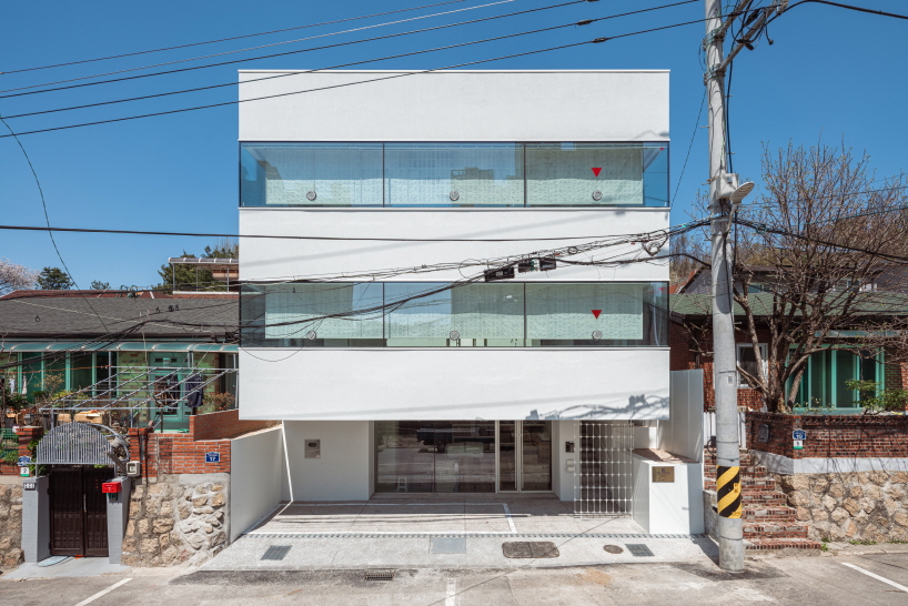 wood hanji shades and intricate metal screens wrap liso architects white office in korea