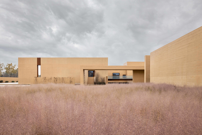 earth-toned concrete walls intertwine to form hot spring hotel by studio A+ in china