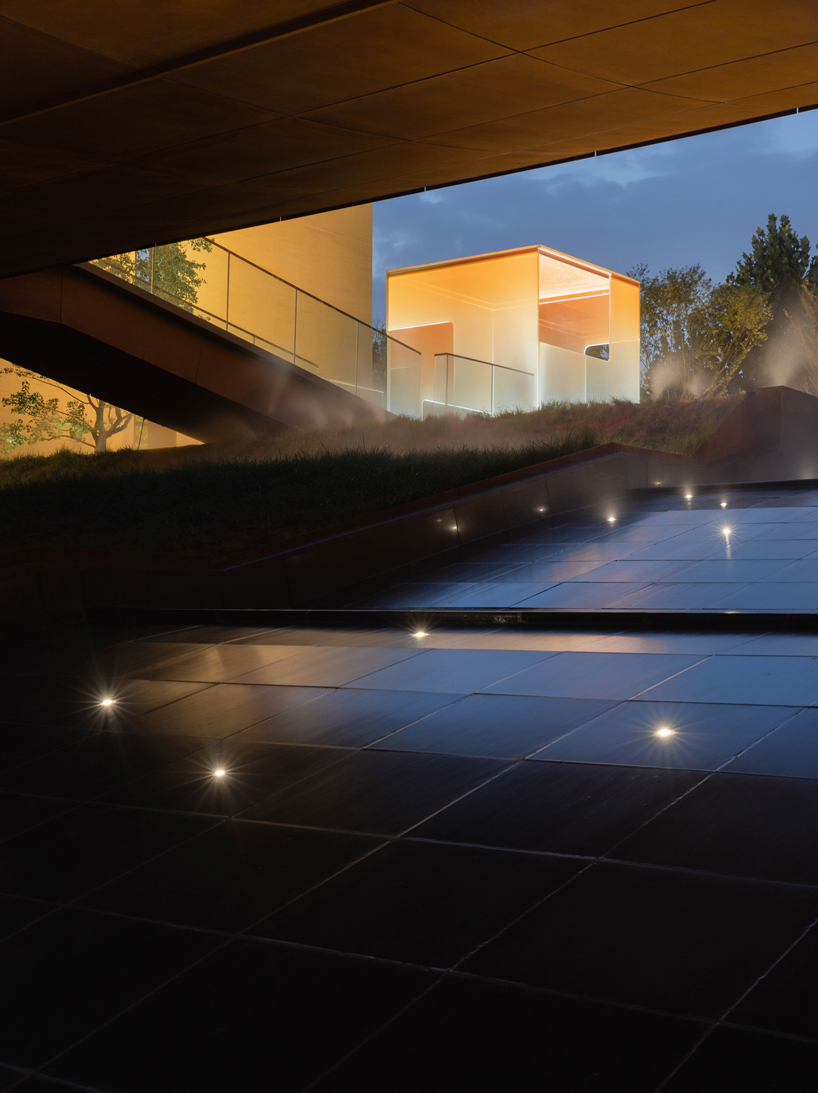 earth-toned concrete walls intertwine to form hot spring hotel by studio A+ in china