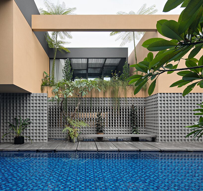 perforated grid facade skin enfolds private retreat in indonesia