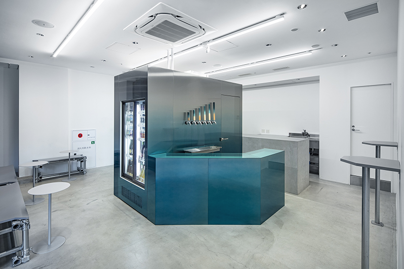 gradient blue walk-in fridge lined with beer taps floats in white interior of taproom in tokyo by yujiro otaki