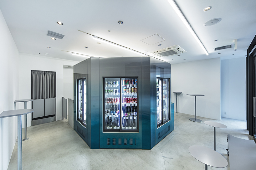 gradient blue walk-in fridge lined with beer taps floats in white interior of taproom in tokyo by yujiro otaki