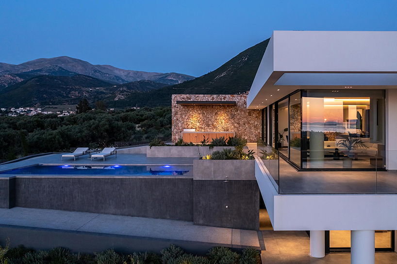 interior and exterior merge within façade studio's geometric panorama residence in greece