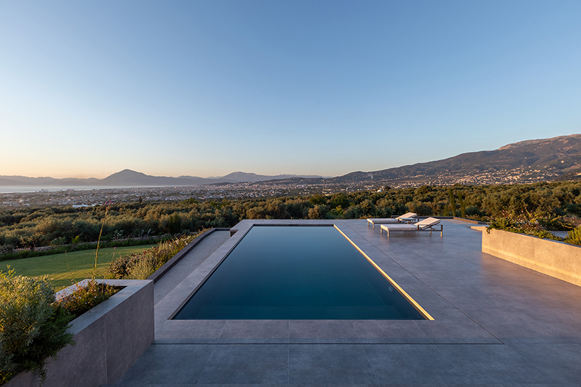 interior and exterior merge within façade studio's geometric panorama residence in greece