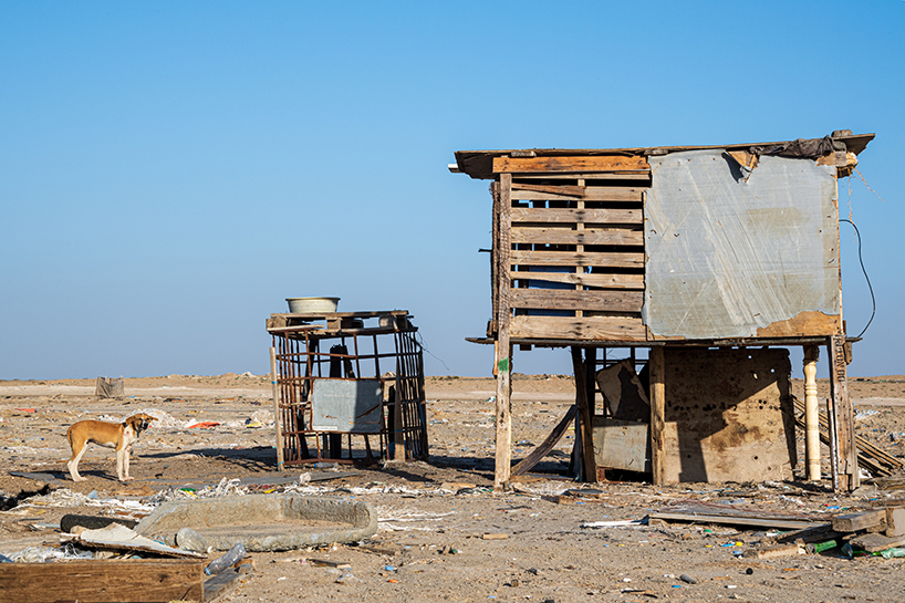 aljohara jeje captures primitive homes made of recycled construction materials + driftwood