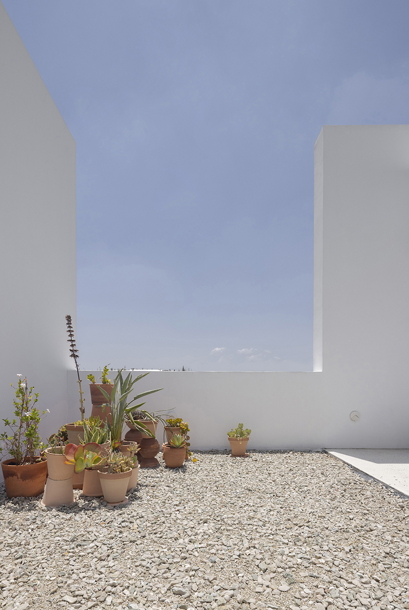 concentric white walls conceal garden-filled residence by draftworks* architects in cyprus
