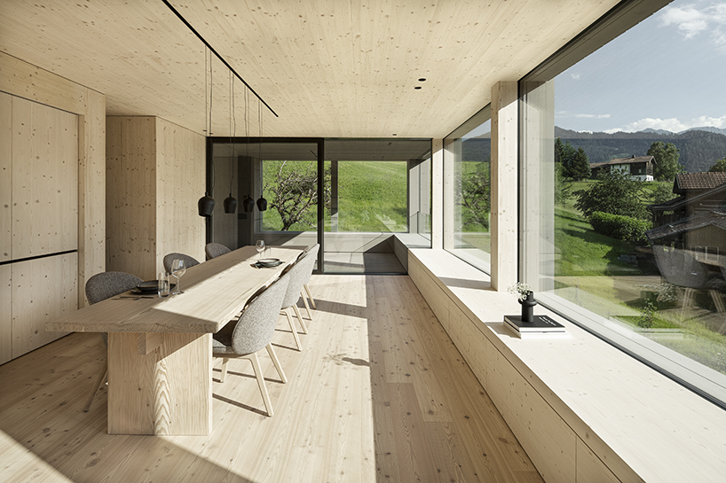 grey wooden framework shapes stable-like residence in swiss village