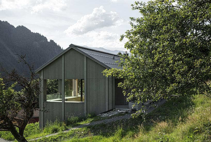 grey wooden framework shapes stable-like residence in swiss village