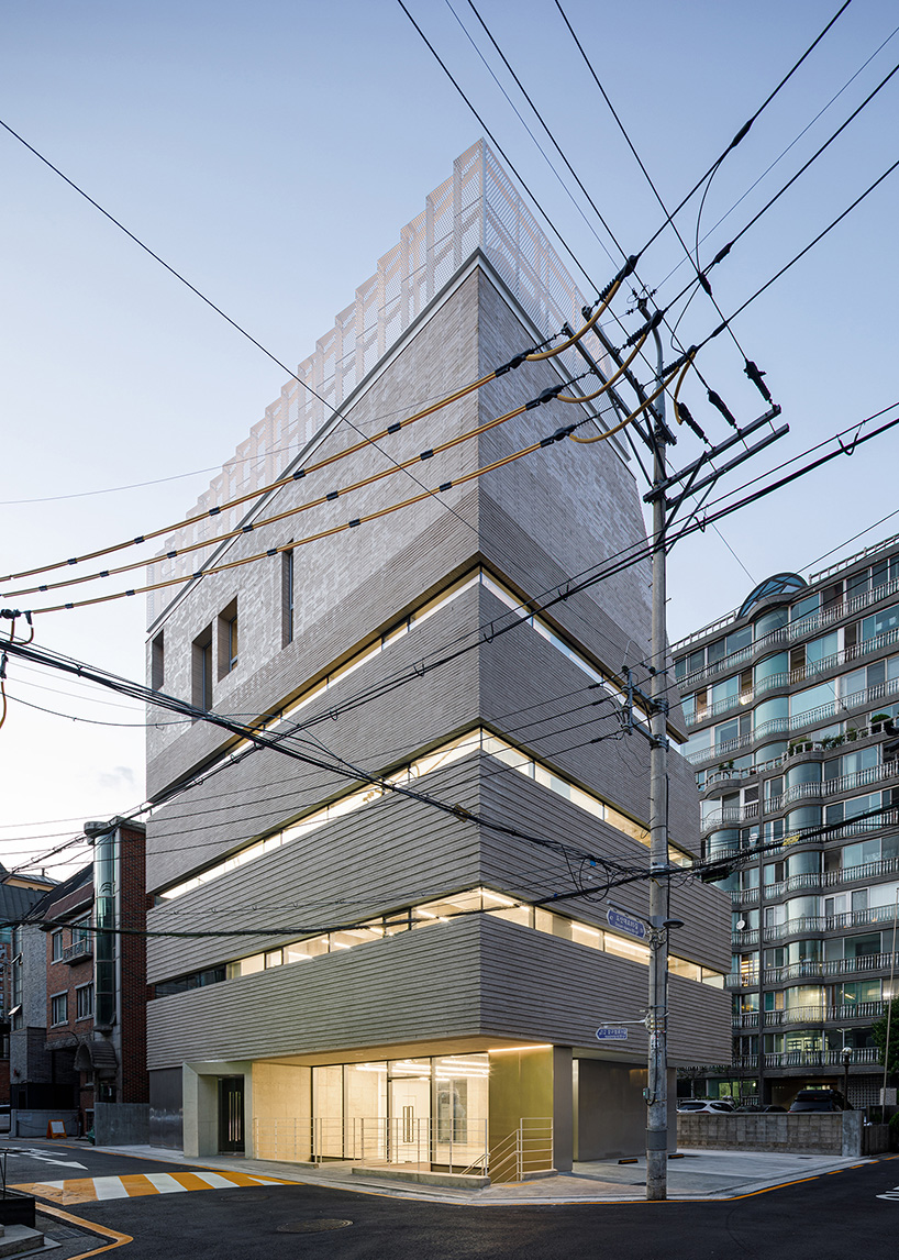 stacked brick multi-level building renders floating illusion in seoul's most popular avenue