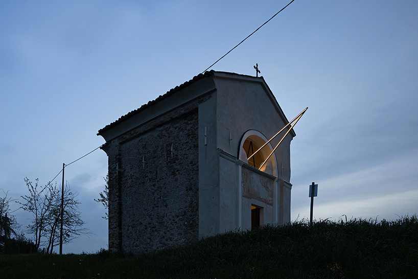 emilio ferro pierces chapel of san rocco with suspended beam of light in italy